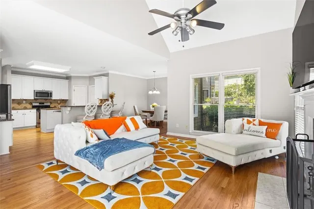 a living room with patio furniture and a flat screen tv