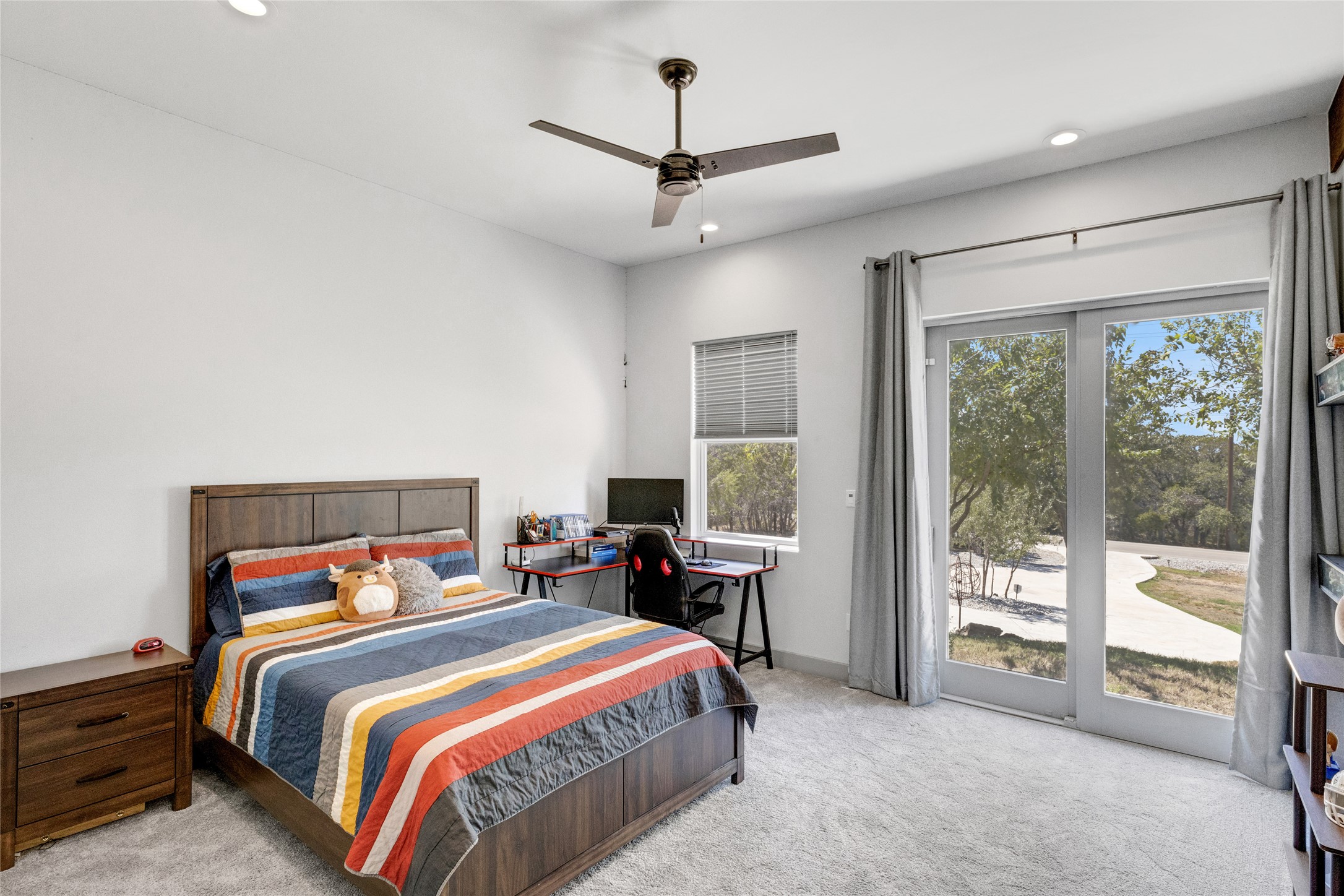 4227 Eck Lane Austin, TX 78734 - Photo 22 of 30 Bedroom with access to outside, light carpet, recessed lighting, and a ceiling fan
