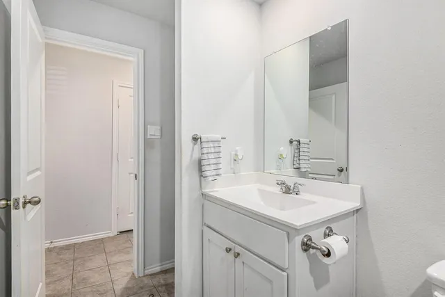 a bathroom with a sink mirror and vanity