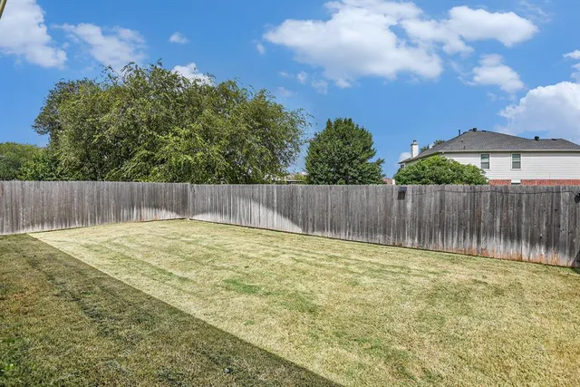 a view of outdoor space with wooden fence