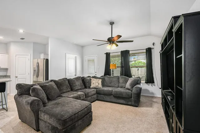 a living room with furniture and a chandelier