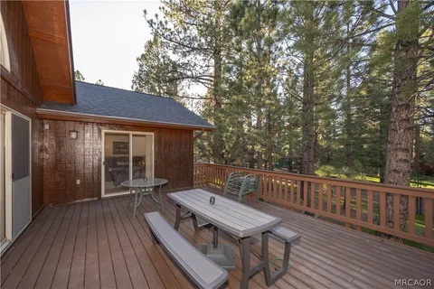 a view of a deck with wooden floor and outdoor seating