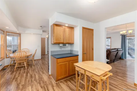 a kitchen with a table chairs refrigerator and cabinets