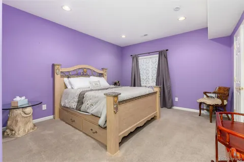 a bed room with a bed and a chair