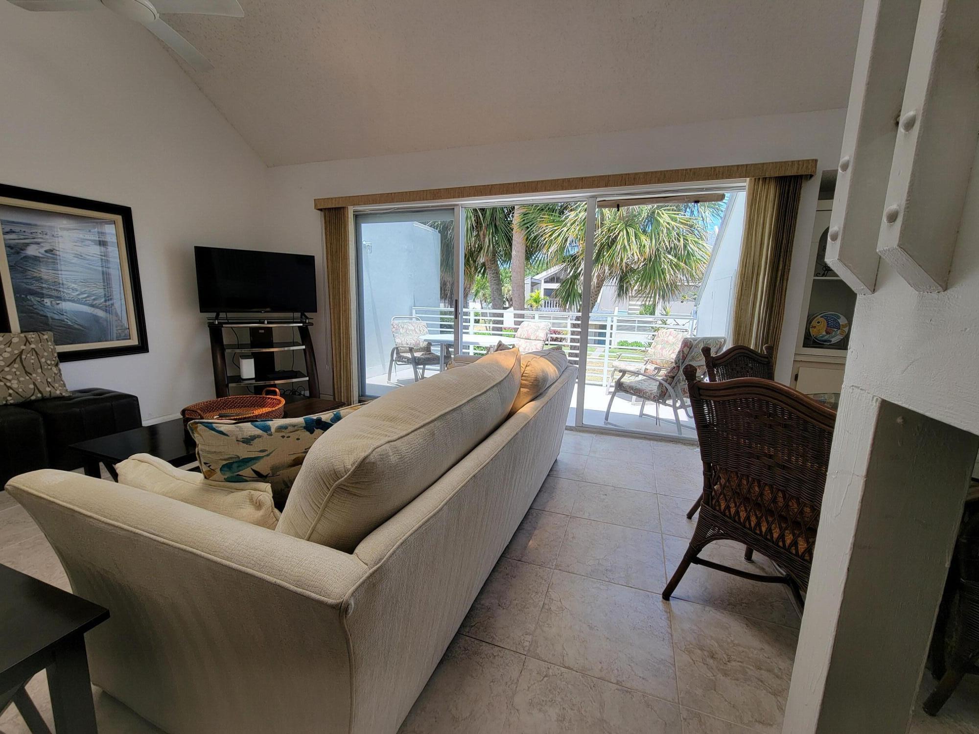 1605 Highway 1, Unit M2210 Jupiter, FL 33477 - Photo 13 of 28 a living room with furniture and a flat screen tv