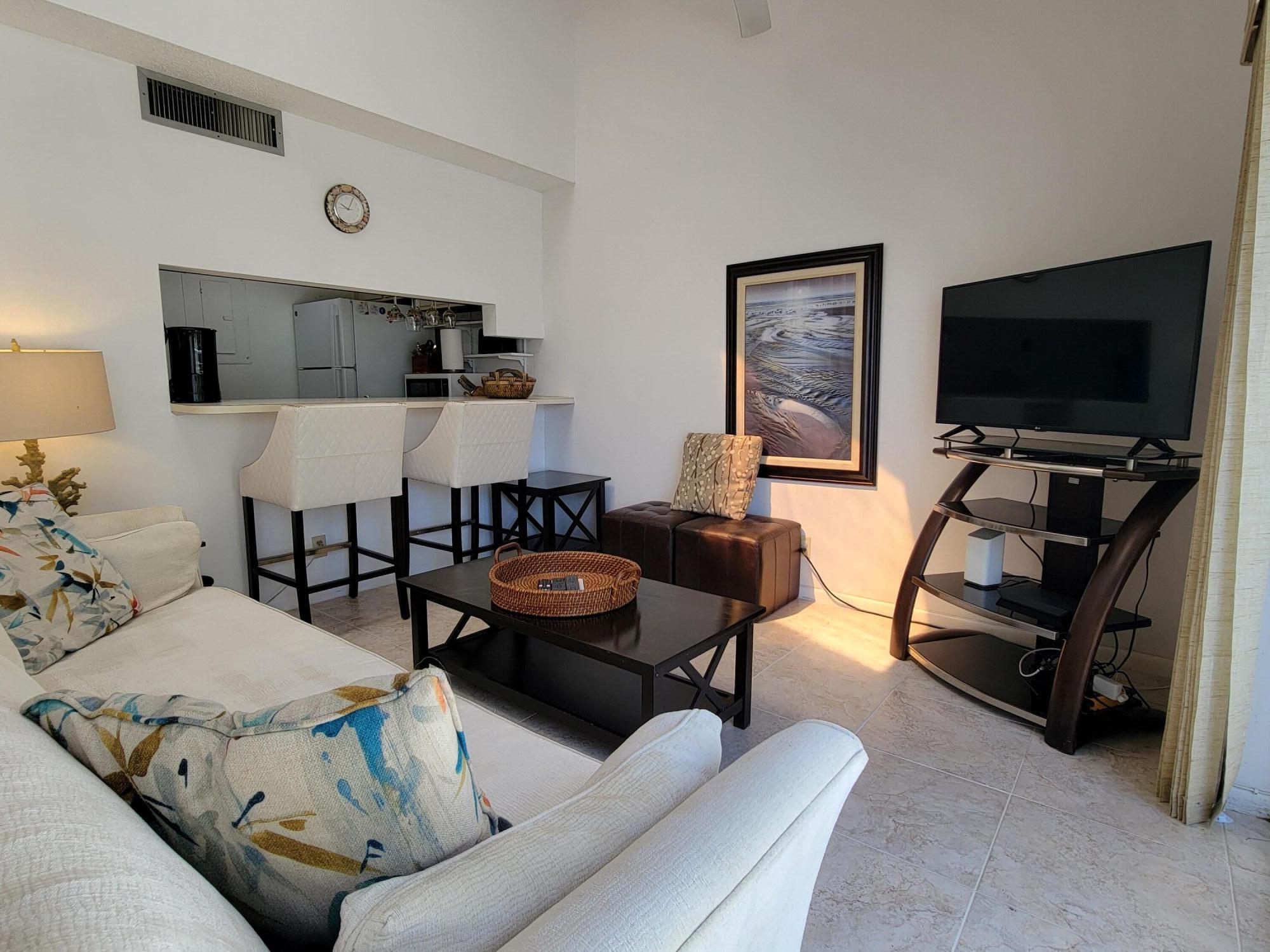 1605 Highway 1, Unit M2210 Jupiter, FL 33477 - Photo 14 of 28 a living room with furniture and a flat screen tv