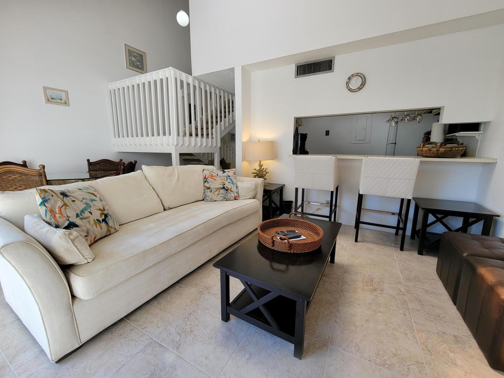 1605 Highway 1, Unit M2210 Jupiter, FL 33477 - Photo 15 of 28 a living room with furniture and a wooden floor