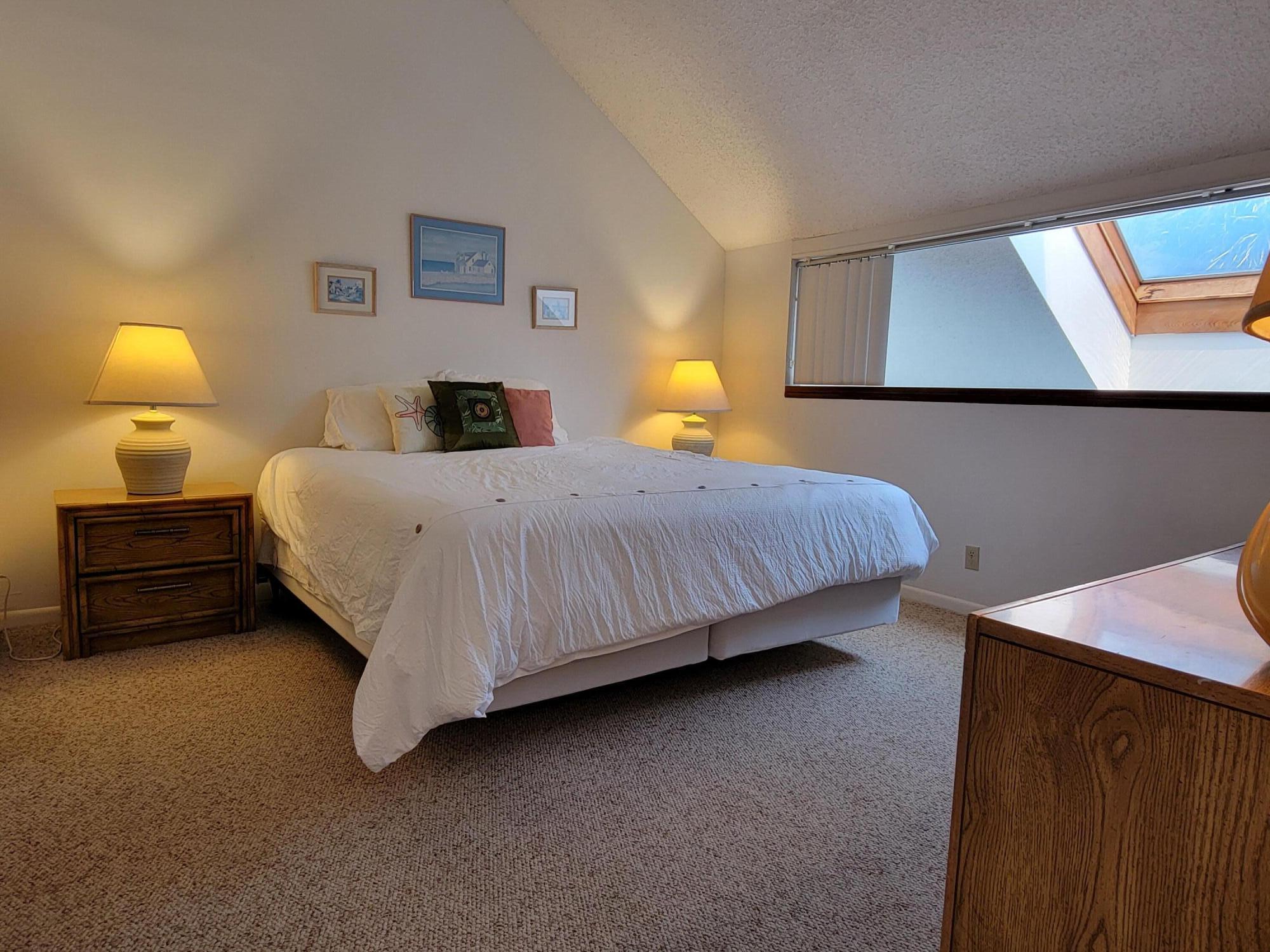 1605 Highway 1, Unit M2210 Jupiter, FL 33477 - Photo 18 of 28 a bedroom with a bed and a night stand