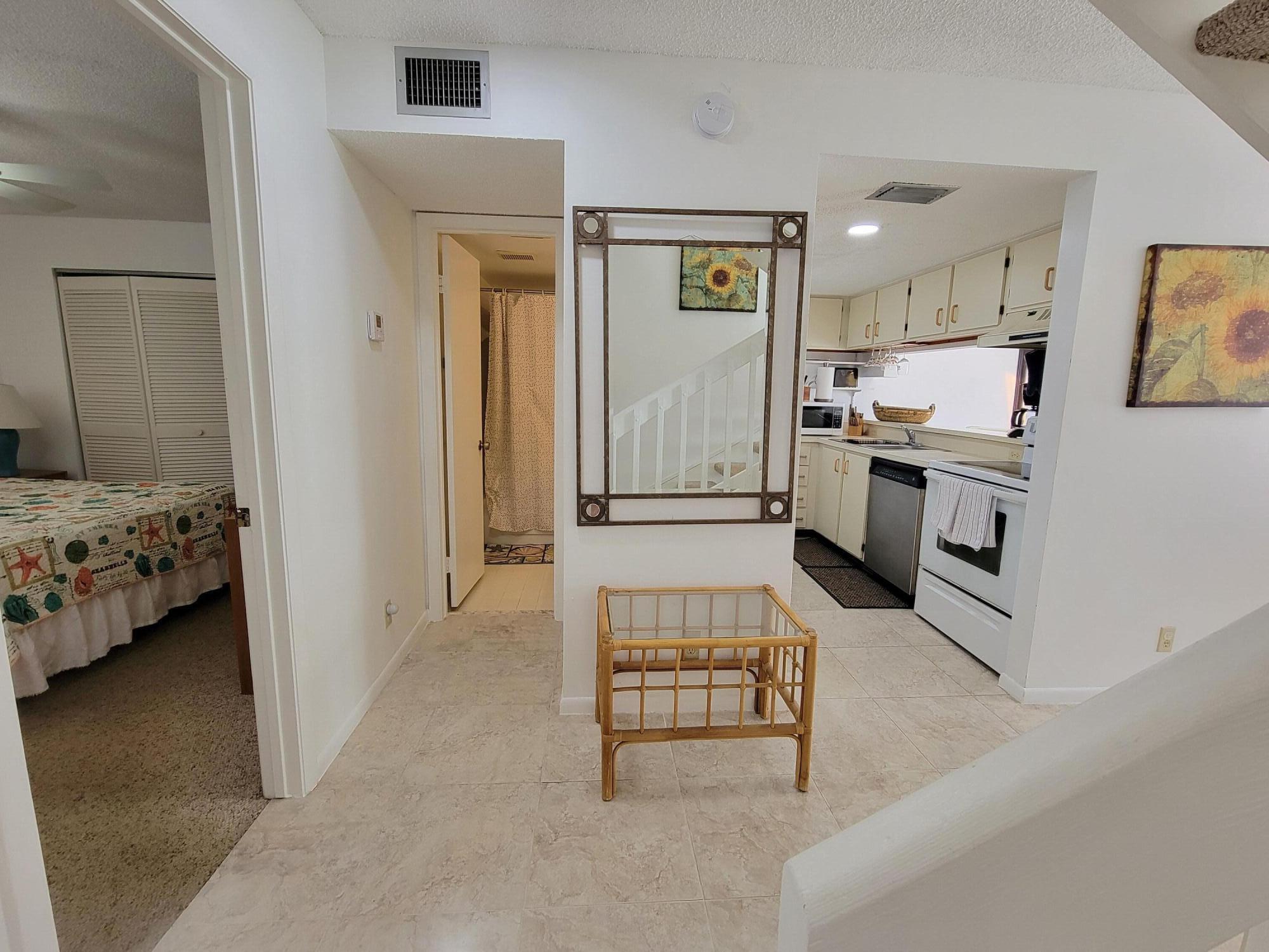 1605 Highway 1, Unit M2210 Jupiter, FL 33477 - Photo 5 of 28 a kitchen with stainless steel appliances kitchen island granite countertop a refrigerator and a stove