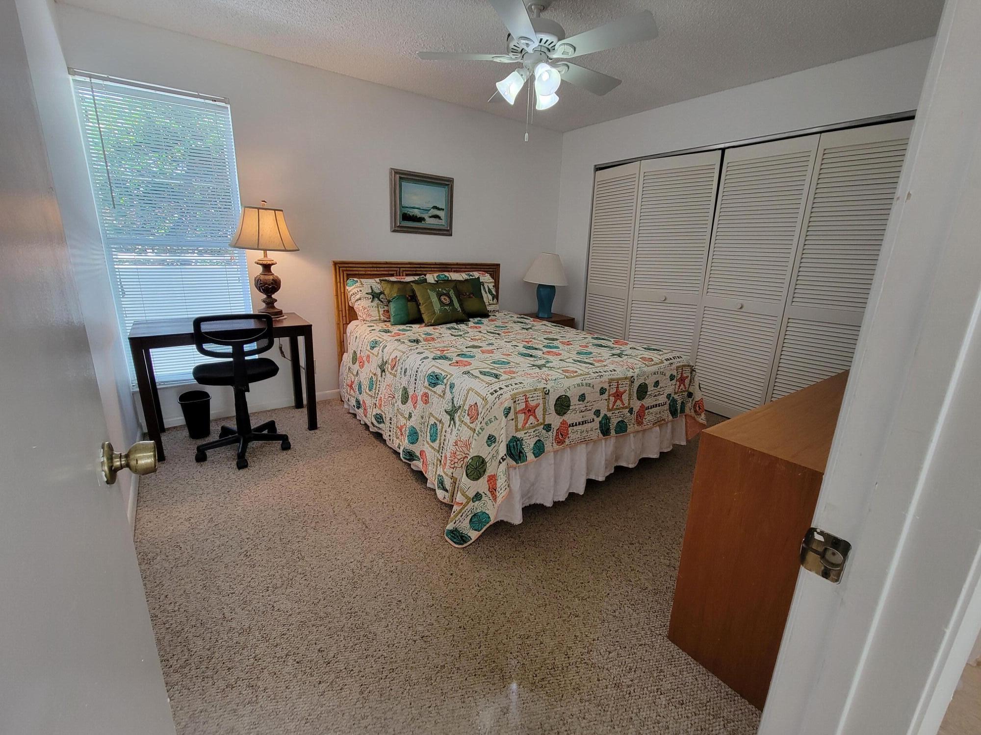 1605 Highway 1, Unit M2210 Jupiter, FL 33477 - Photo 6 of 28 a bedroom with bed and window
