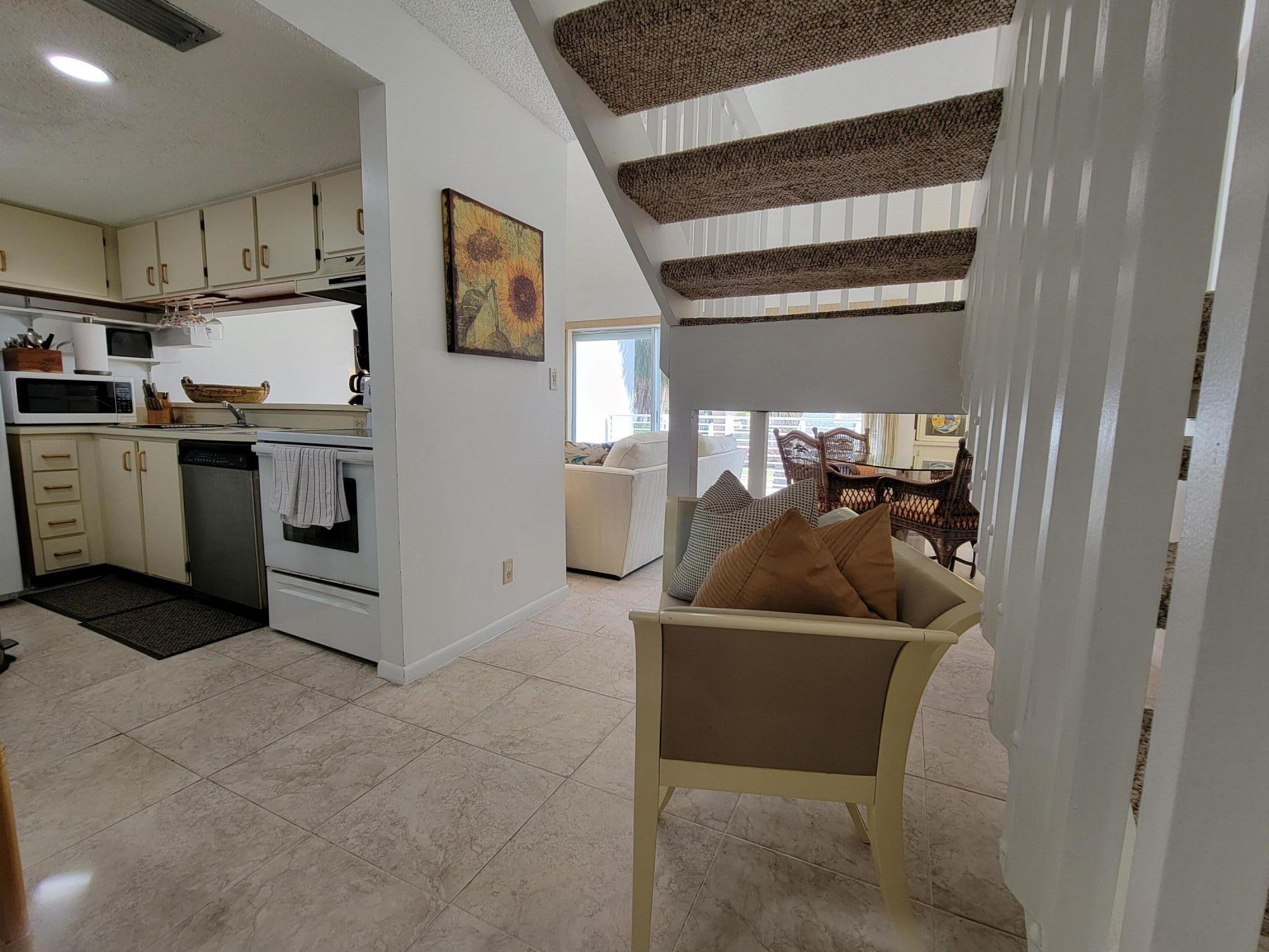 1605 Highway 1, Unit M2210 Jupiter, FL 33477 - Photo 9 of 28 a kitchen with a refrigerator and a sink