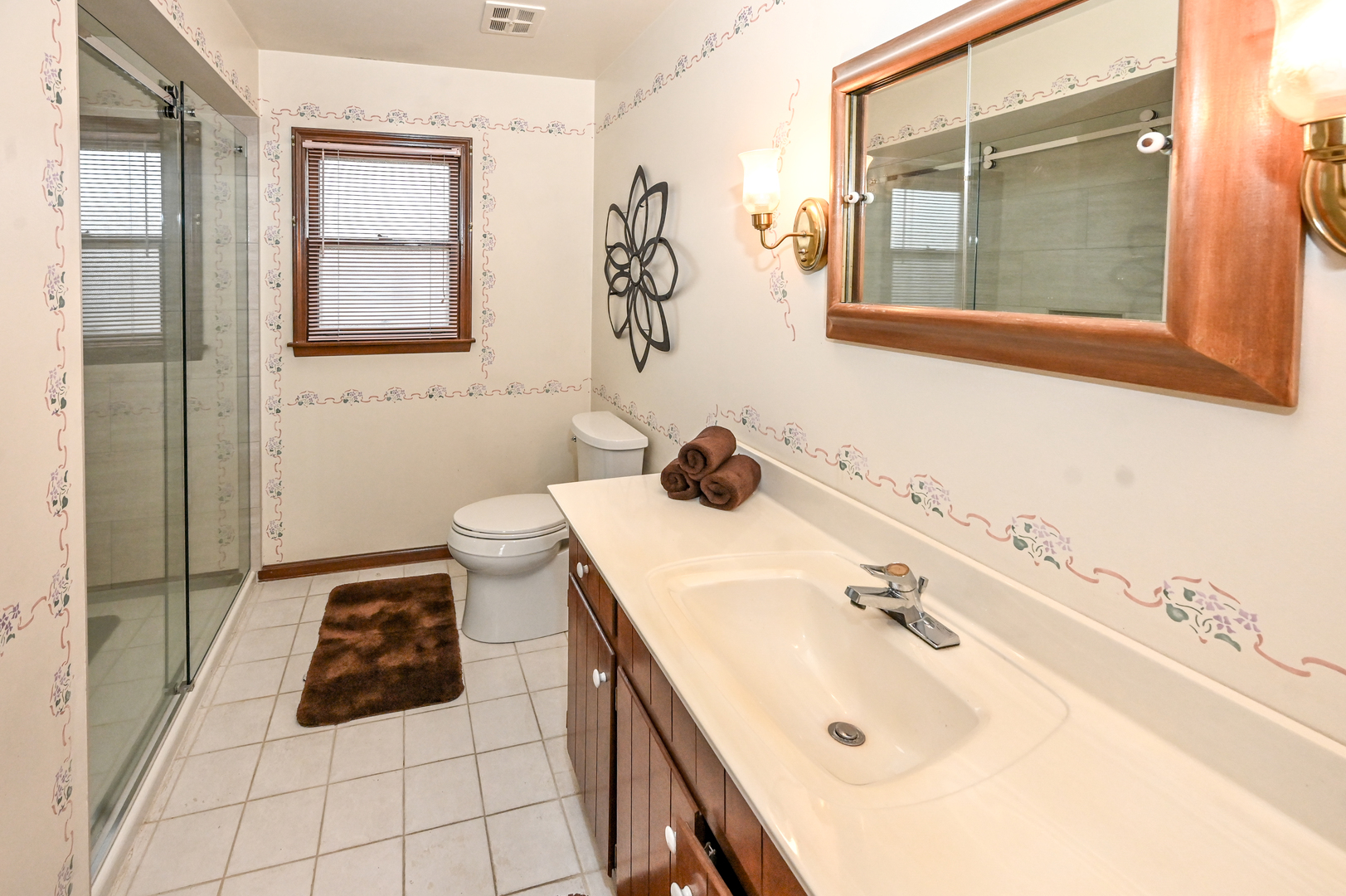 249 South Arlington Heights Road Elk Grove Village, IL 60007 - Photo 18 of 21 a bathroom with a sink a toilet and mirror