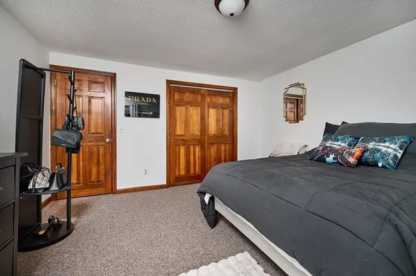 a bedroom with a bed and a desk