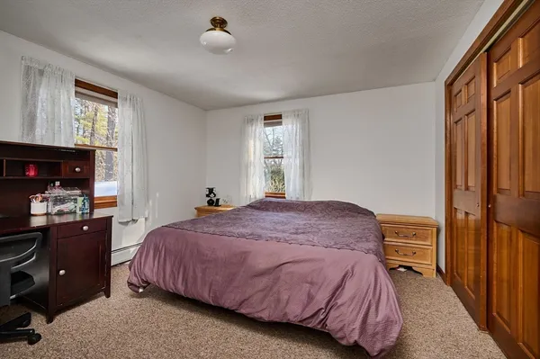 a bedroom with a bed and a closet
