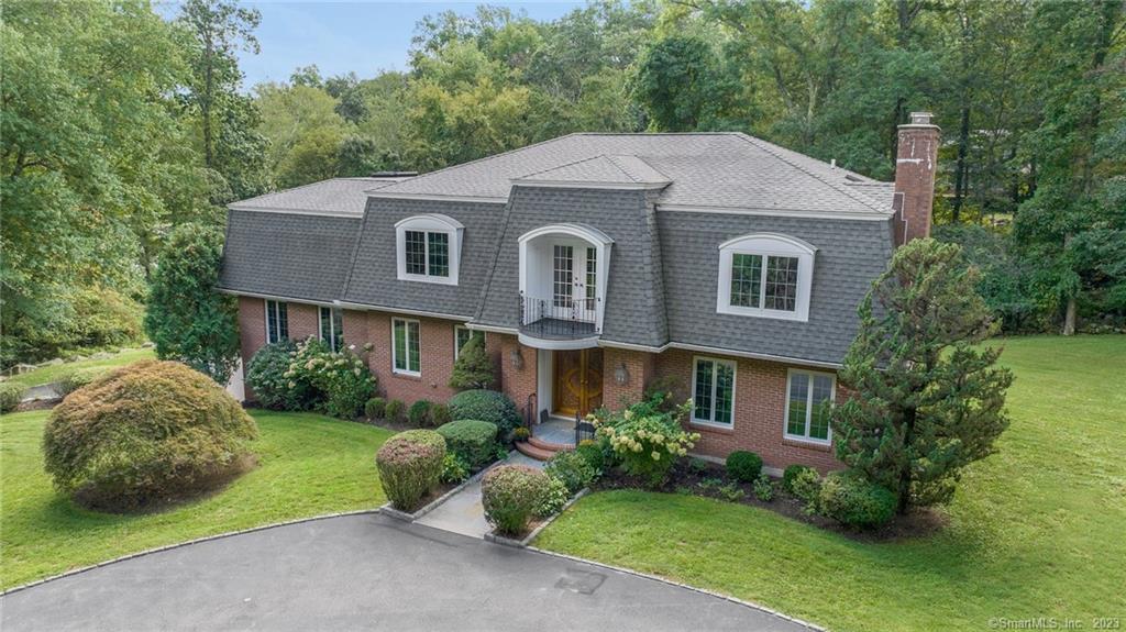 a aerial view of a house next to a yard