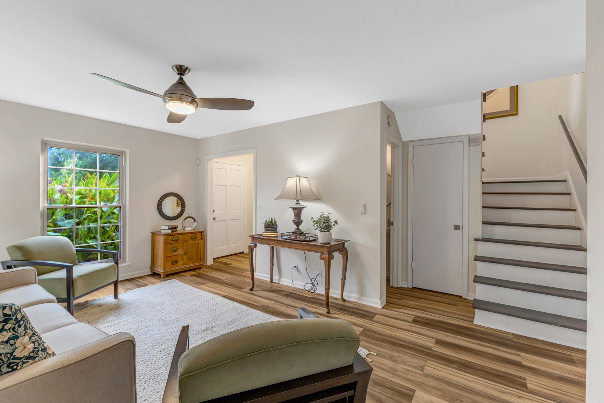 a bedroom with furniture and a large window