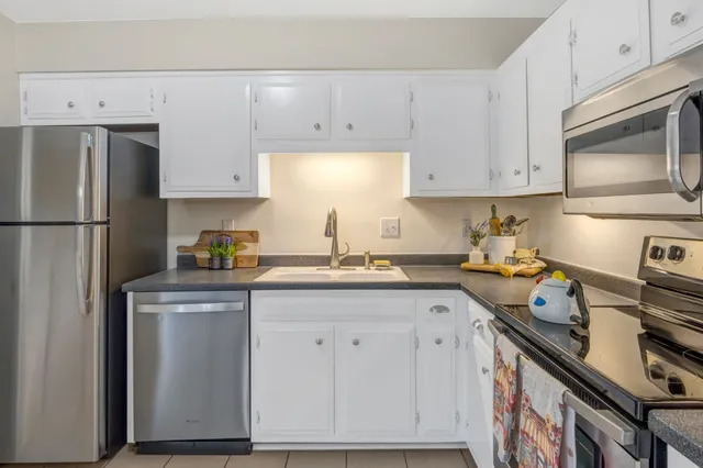 a kitchen with cabinets appliances and a sink