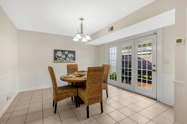 a view of a dining room with furniture and chandelier