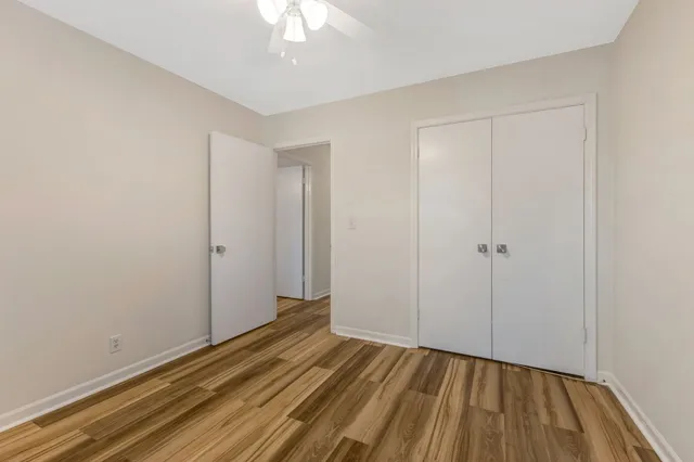 a view of hallway with wooden floor