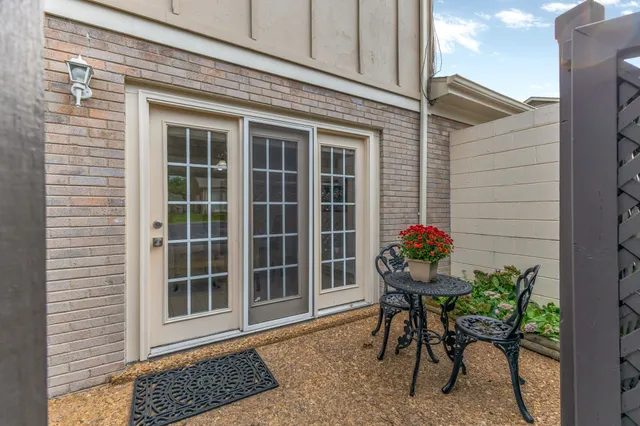 a view of a house with backyard porch and sitting area