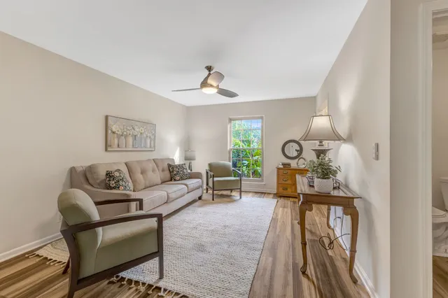 a living room with furniture and a clock