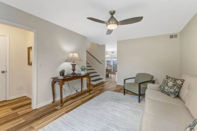 a living room with furniture and a wooden floor