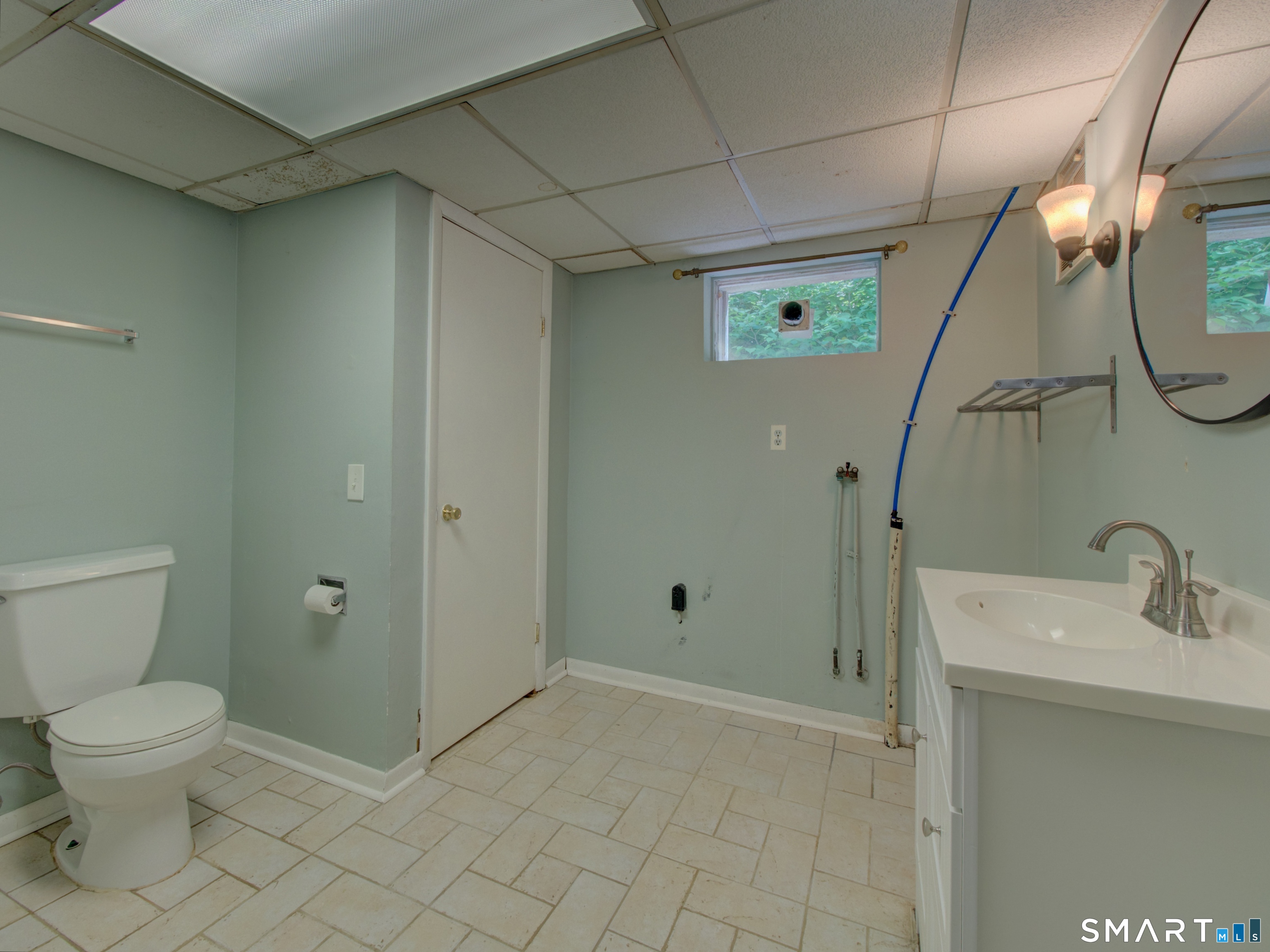 311 Sandy Hollow Road Groton, CT 06355 - Photo 19 of 26 a bathroom with a sink a toilet and shower