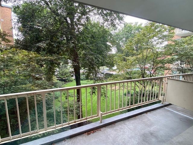 a kitchen with granite countertop a refrigerator and a stove top oven