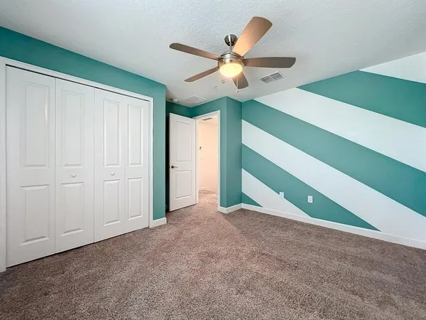 an aerial view of a house with a yard and lake view