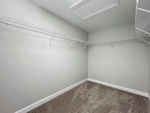 a spacious bathroom with a granite countertop sink a toilet a mirror and shower