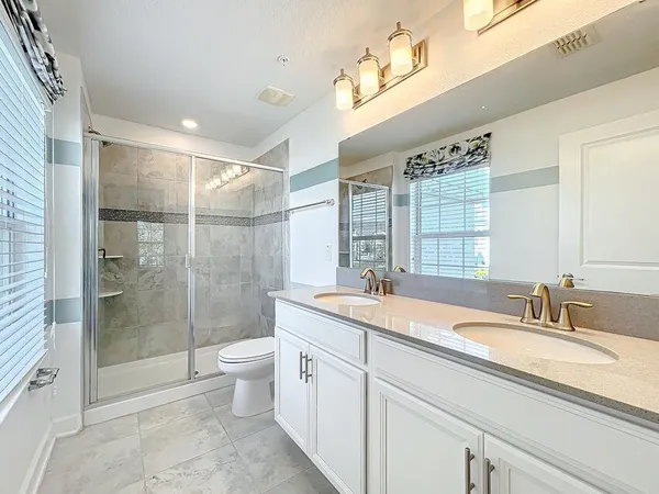 a bathroom with a sink double vanity and a mirror
