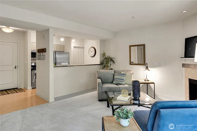 a living room with furniture a dining table and a window