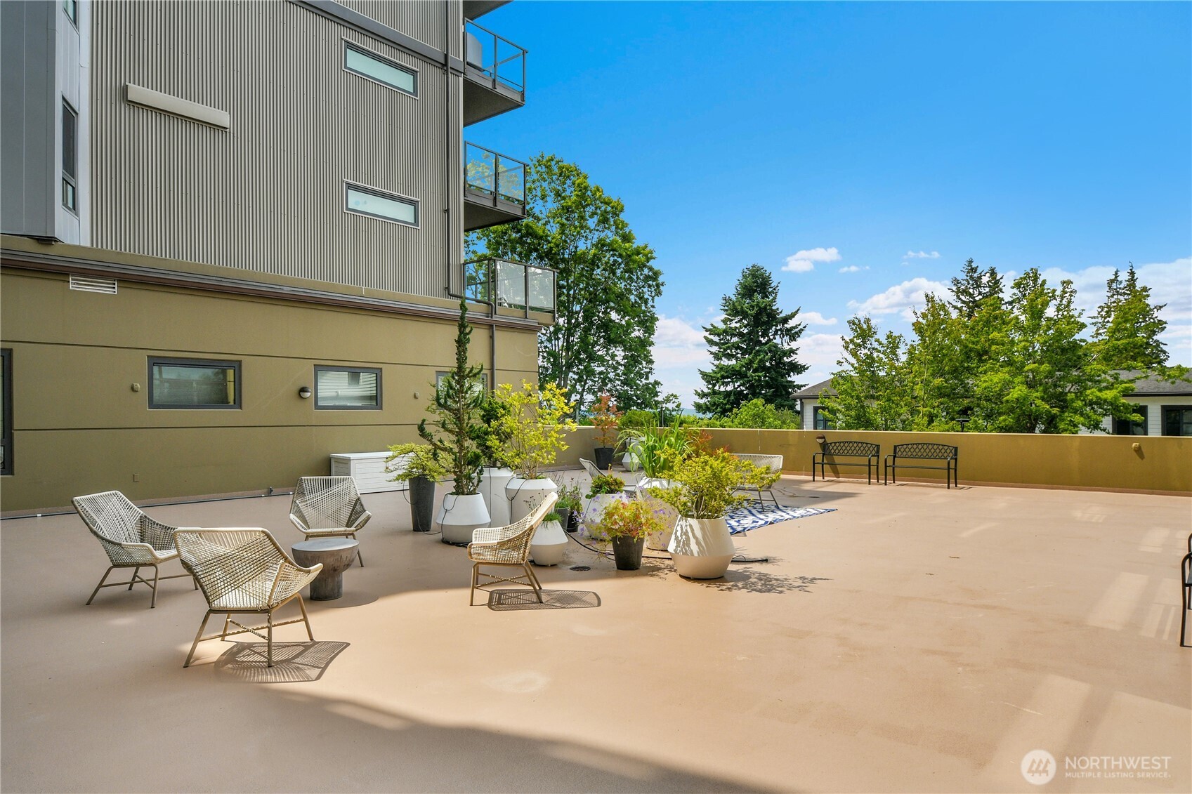 5001 California Avenue Southwest, Unit 212 Seattle, WA 98136 - Photo 6 of 18 a view of a patio with a table and chairs and potted plants
