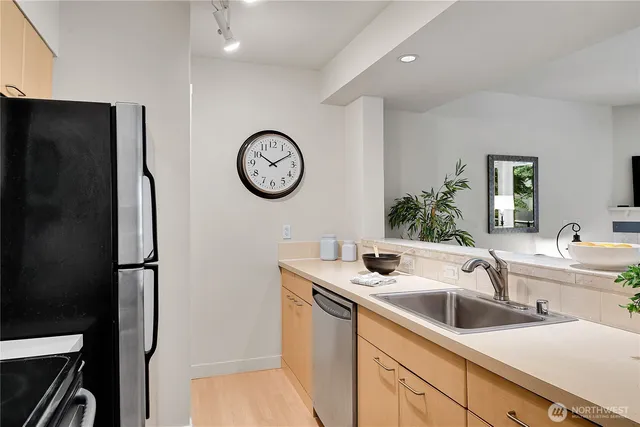 a kitchen with a refrigerator stove and white cabinets