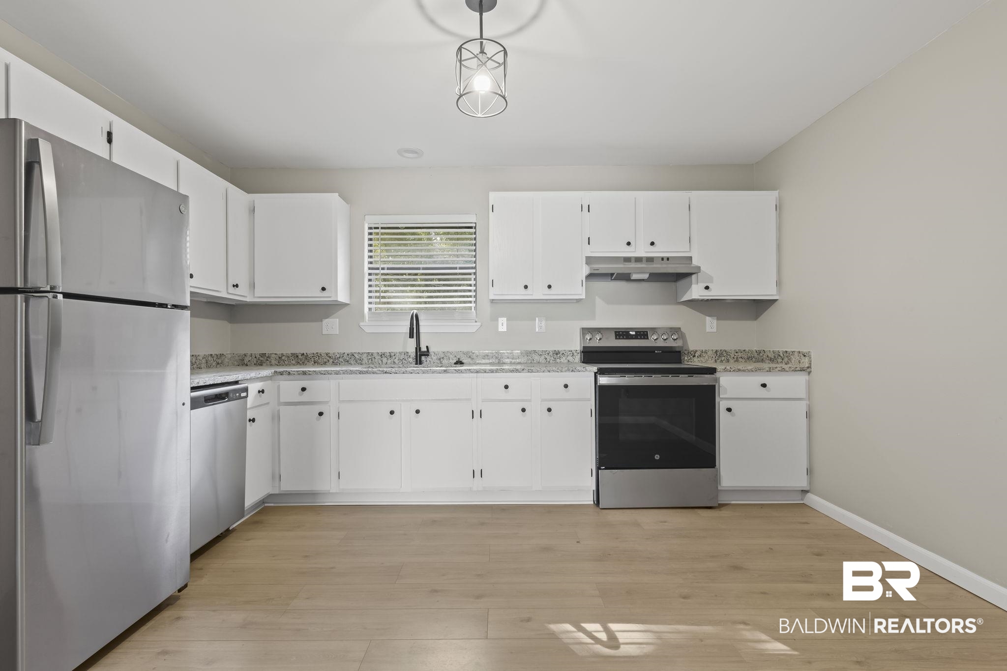 309 West Roosevelt Avenue Foley, AL 36535 - Photo 8 of 60 Kitchen featuring sink, hanging light fixtures, light hardwood / wood-style flooring, appliances with stainless steel finishes, and white cabinetry