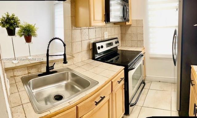 a close view of a sink a counter and appliances in a kitchen