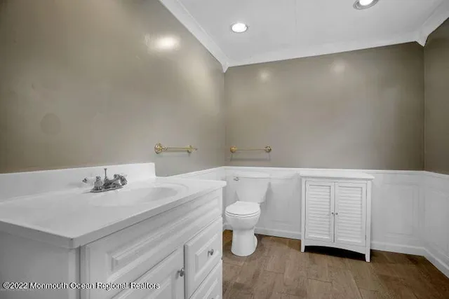 a bathroom with a sink a toilet and vanity