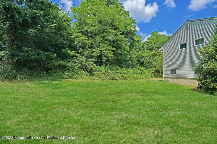 5 Arlene Drive West Long Branch, NJ 07764 - Photo 16 of 17 a view of a backyard with potted plants and large tree
