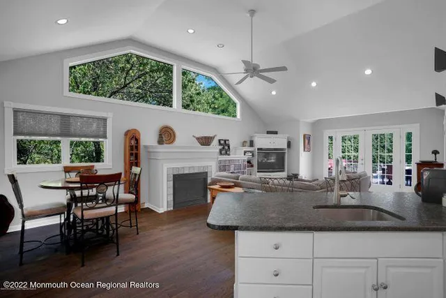 an open kitchen with furniture and a fireplace