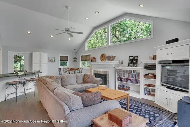 a living room with furniture a flat screen tv and a fireplace