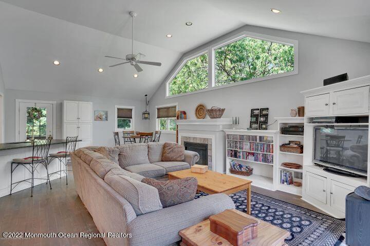 5 Arlene Drive West Long Branch, NJ 07764 - Photo 7 of 17 a living room with furniture a flat screen tv and a fireplace