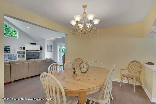 a view of a dining room with furniture and chandelier