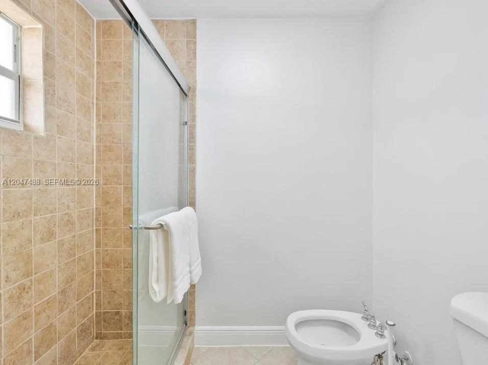 9840 Southwest 3rd Street Miami, FL 33174 - Photo 19 of 25 a bathroom with a toilet and a shower