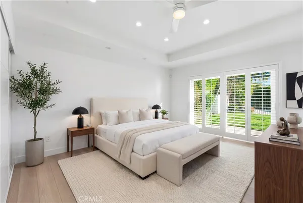 a bedroom with bed and a potted plant