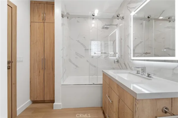 a bathroom with a sink a mirror and shower