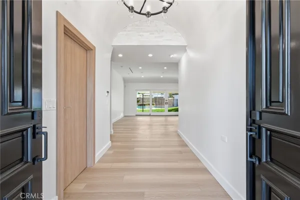 a view of a hallway with wooden floor and staircase