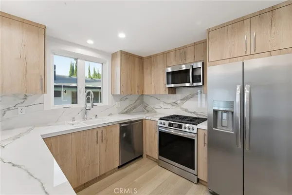 a kitchen with a sink stove and refrigerator