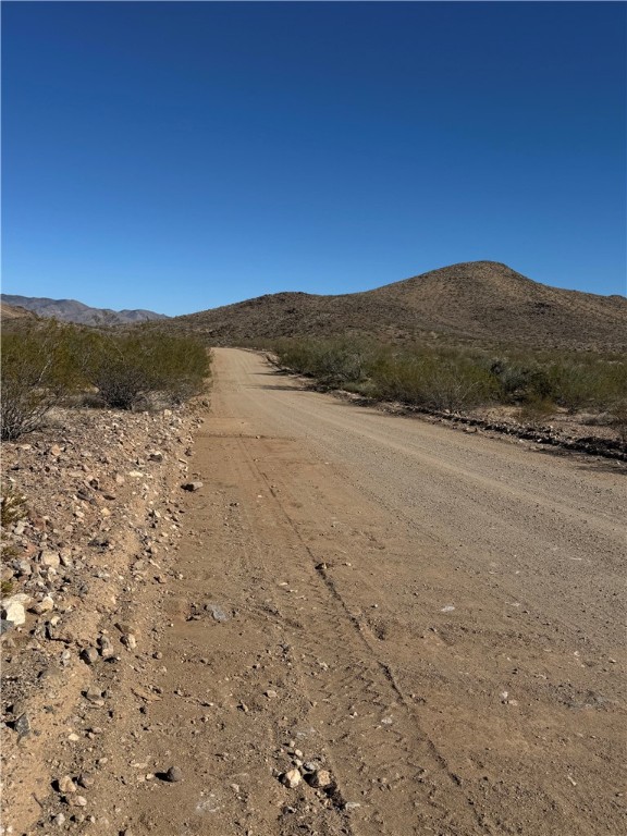 33909081 North Cibola Road Golden Valley, AZ 86413 - Photo 21 of 23 View of dirt / gravel road with a mountain view