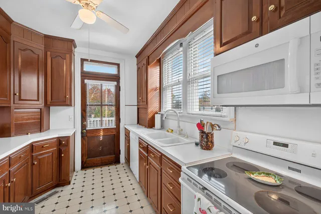 a kitchen with stainless steel appliances a refrigerator sink and cabinets