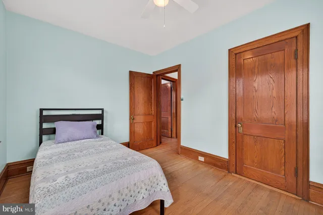 a spacious bedroom with a bed and a window